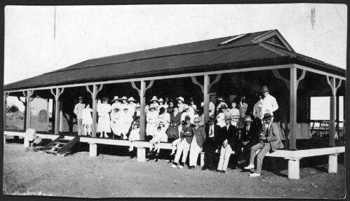 A group portrait of townsfolk and visitors on the porch of the new Port Hedland hospital during its opening, Western Australia [picture] / [John Flynn?]