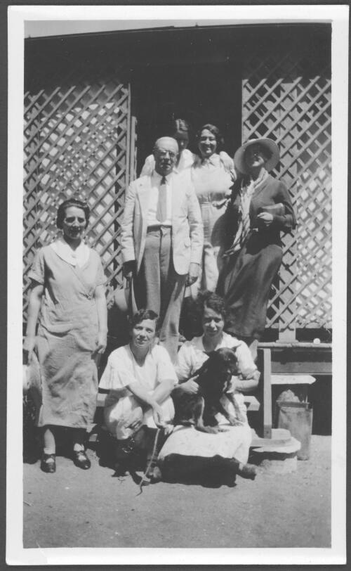 Portrait of the Port Hedland Hospital staff, Dr. Webster, Sisters Farmer, Pearson, Tamish, Tamish, J. Lochhead, Reid and Jock the dog, on the steps of the staff entrance, Western Australia, 14 September, 1935 [picture] / [John Flynn?]