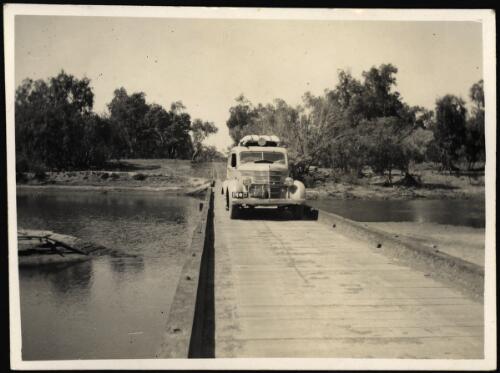 View of a car on a bridge at Yeeda Crossing on the Fitzroy River, 112 miles from Broome, Western Australia, 11 August, 1941 [picture] / [John Flynn?]