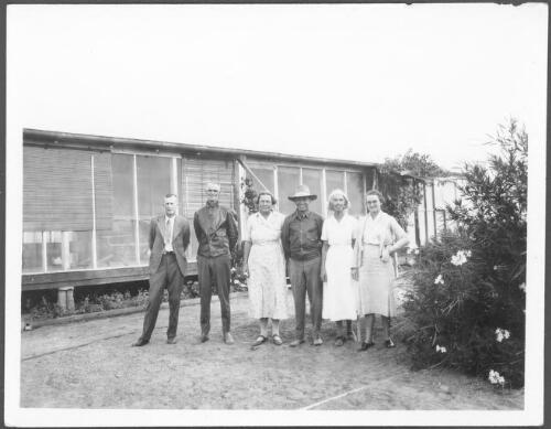 Group portrait of Reverend Partridge, Mr. Gillespie, Mrs. Drummond, Mr. Stone, Miss Gillespie and Mrs. Goy outside the Clyde homestead, Western Queensland [picture] : photographs taken by C.T.F. Goy during his North Australia patrol, 1937-1942 / C.T.F. Goy