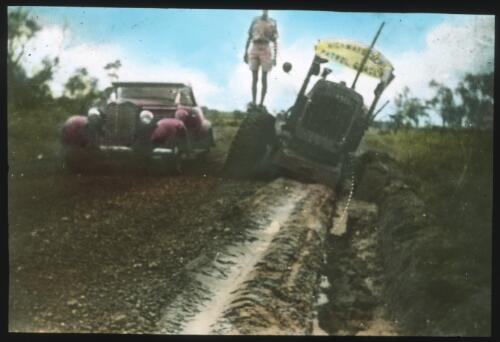 Tractor on the edge of a road, [2] [transparency] / [John Flynn?]