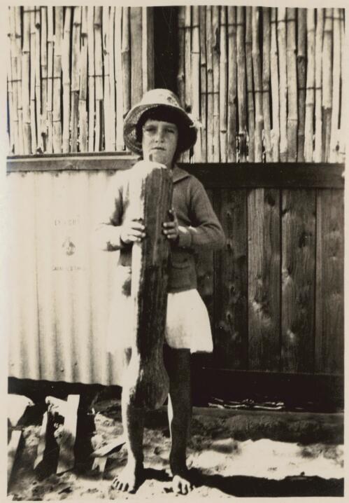 Iris Callanan, aged 8 years, holding trombone pumpkin grown at Maranboy, 1925 [picture] / [John Flynn?]