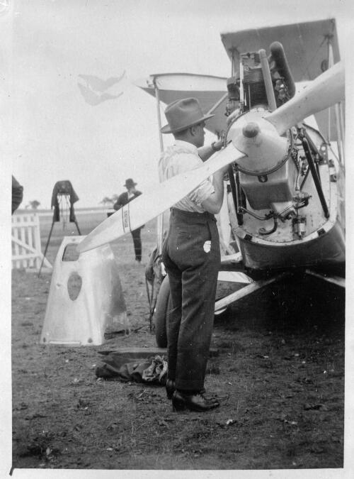[Bert Hinkler attending the engine of the Avro Avian he flew from England to Australia, Canberra, 1928] [picture] / A. Collingridge