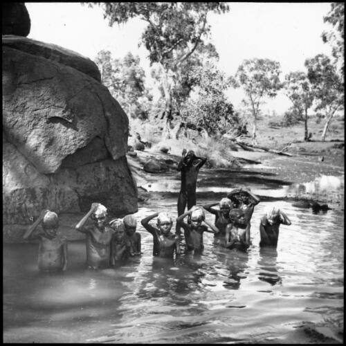 Children bathing in a rock pool at Ernabella, South Australia, 1949 [transparency] / C. Duguid