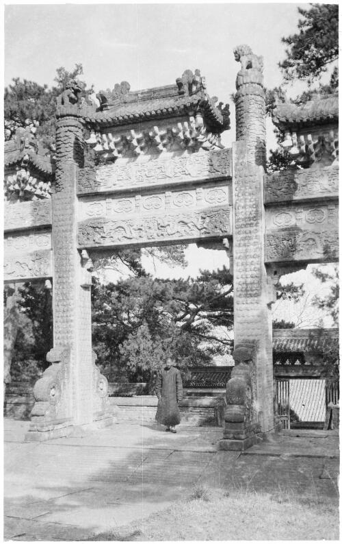 [Memorial arch in a Budhist monastery with lions either side on top of high columns and a monk, China, ca. 1930] [picture] / Stanley O. Gregory