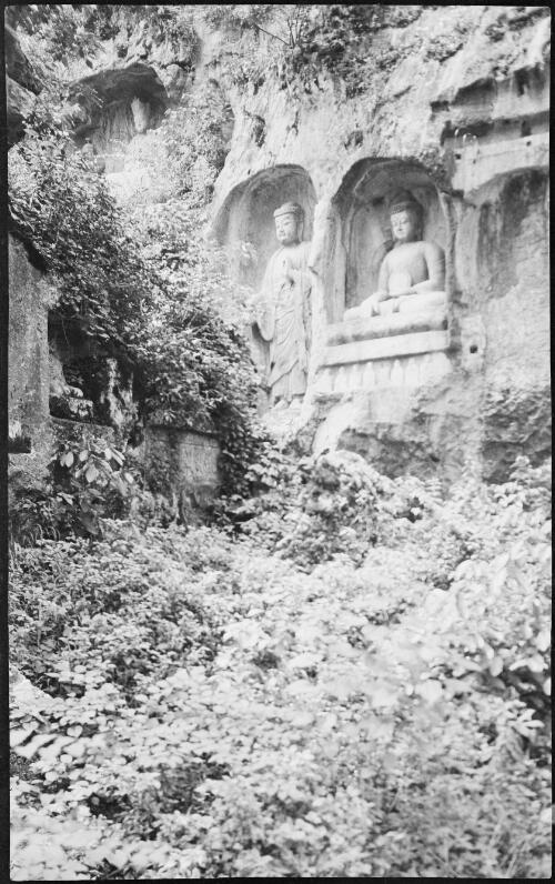 [Sculptures in Hangchon carved out of rock wall with a seated and a standing buddha on another higher wall, China, ca. 1930] [picture] / Stanley O. Gregory