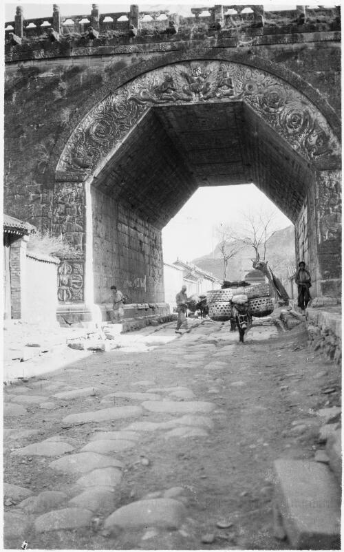 [Large flat bolders in roadway leading to bridge with decorated entrance and five sided archway, China, ca. 1930] [picture] / Stanley O. Gregory