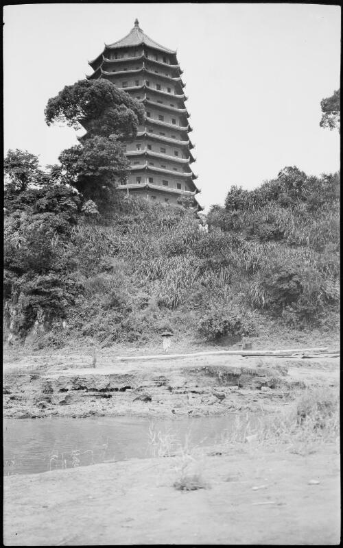 [Pagoda at Kashing Chekiang behind vegetation and small figure with parasol near river bank, China, ca. 1930] [picture] / Stanley O. Gregory