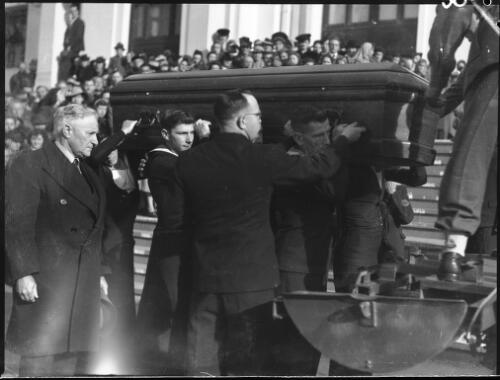 The coffin of Prime Minister John Curtin being lifted onto a gun carriage in front of Parliament House, Canberra, on 6 July 1945 [picture] / L.J. Dwyer