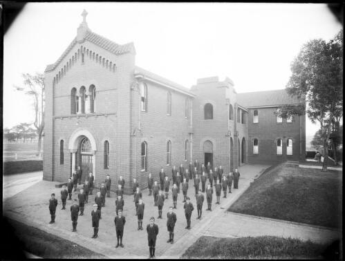 Small group of boys lined up outside the school [picture] / A.G. Foster