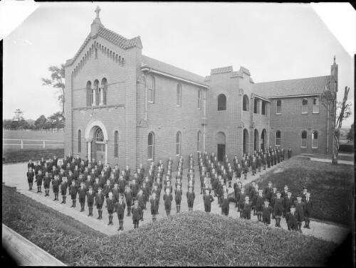 Large group of boys at assembly in front of the school [picture] / A.G. Foster