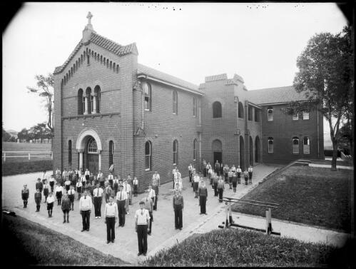 Group of students at assembly in front of the school [picture] / A.G. Foster