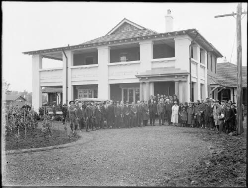 Group standing in front of building [picture] / A.G. Foster