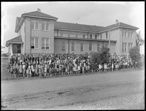 Group of school students and teachers outside their school [picture] / A.G. Foster