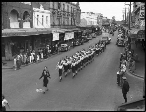 Women in uniforms marching in a parade along Church Street, Parramatta, Sydney [picture] / A.G. Foster