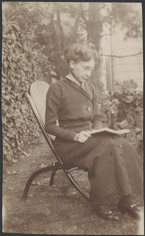Portrait of Mathilde Elizabeth Deane reading in a garden, ca. 1920s [picture]