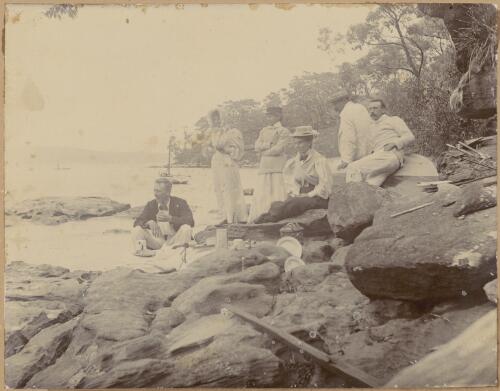 Group portrait of Anna Maria [?] and Mathilde Elizabeth Deane [?] with one unidentified woman and three unidentified men having a picnic on rocks, ca. 1900s [picture]