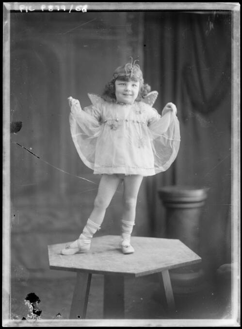 Young girl in fairy costume standing on three legged table [picture] / Arthur William Emmerton