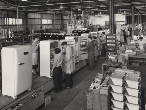 [Men and women working on fridges in a large factory space], Pope Industries, Adelaide,  SA, 1958 [picture] / Wolfgang Sievers