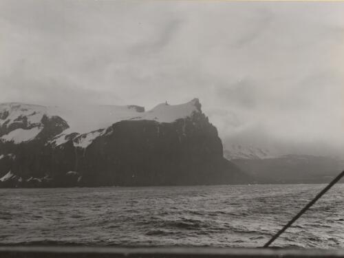Glacier-capped black cliffs, Heard Island, Antarctica, 1948 [picture] / D. Eastman