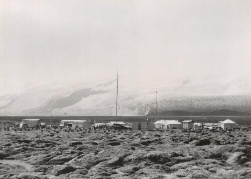 The Heard Island Scientific station crouches almost at the foot of the Baudessin [i.e. Baudissin] Glacier, Antarctica, 1955 [picture] / George Lowe