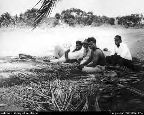 Four men sit in the shade of a tree at the Mission Station, Cape York, North Queensland, 1957 [picture] / Wolfgang Sievers
