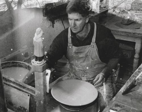 Richard Murray, local potter, working at the wheel in his studio, Braidwood, New South Wales, February 1996 [picture] / Terry Milligan