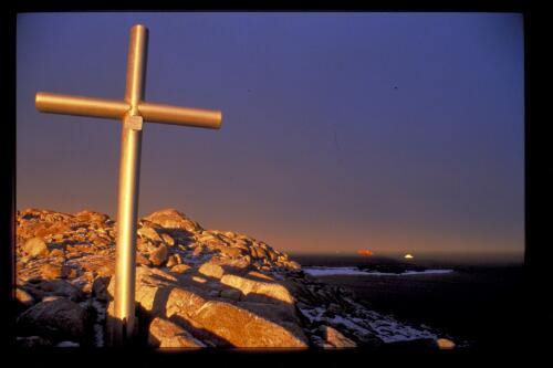 A memorial cross devoted to Geoffrey Reeve, who died in 1979, stands on Reeve Hill overlooking Casey Harbour, Casey Station, Antarctica, 10 January 1998 [transparency] / Felicity Jenkins