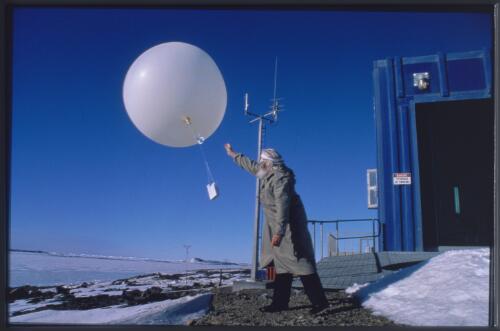 Meteorology weather forecaster Neville Martin releases the evening weather balloon which collects data of local atmospheric and weather conditions around Davis Station, Antarctica, 9 November 1997 [transparency] / Felicity Jenkins