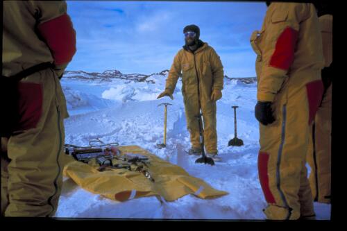 Field Training officer Andy Cianchi demonstrates the application of emergency equipment to expeditioners during field training, Davis Station, Antarctica, 10 November 1997 [transparency] / Felicity Jenkins
