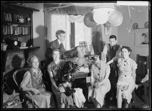 Harold Cazneaux with his family on Christmas morning opening presents in the dining room at Ambleside, Roseville, New South Wales, December 1936 [picture] / Harold Cazneaux