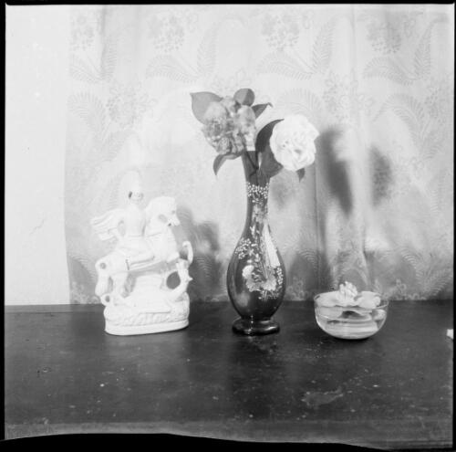 Two camellias in a vase with a figurine of St. George and the dragon to the left, Melbourne, ca. 1955 [picture] / Sarah Chinnery