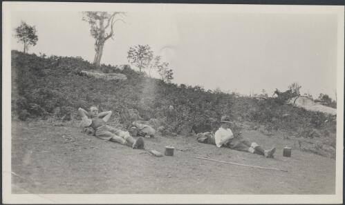 Charles Studdy Daley and an unidentified man reclining against their packs, ca. 1925 [picture]
