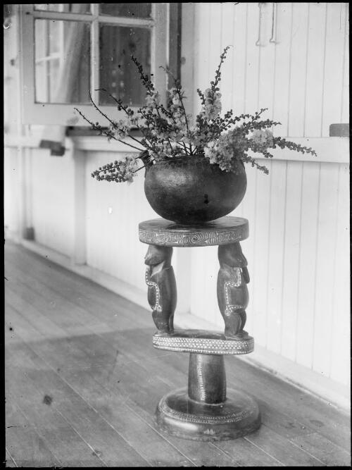 New Guinea flowers in a round bowl on a Trobriand Island stool, Rabaul, New Guinea, ca. 1929 [picture] / Sarah Chinnery