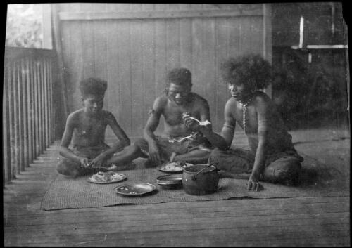 Three Papuans eating on a verandah, Papua, ca. 1923 [picture] / Sarah Chinnery