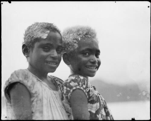Two young girls, wearing European style clothing with limed hair, New Guinea, ca. 1929 [picture] / Sarah Chinnery