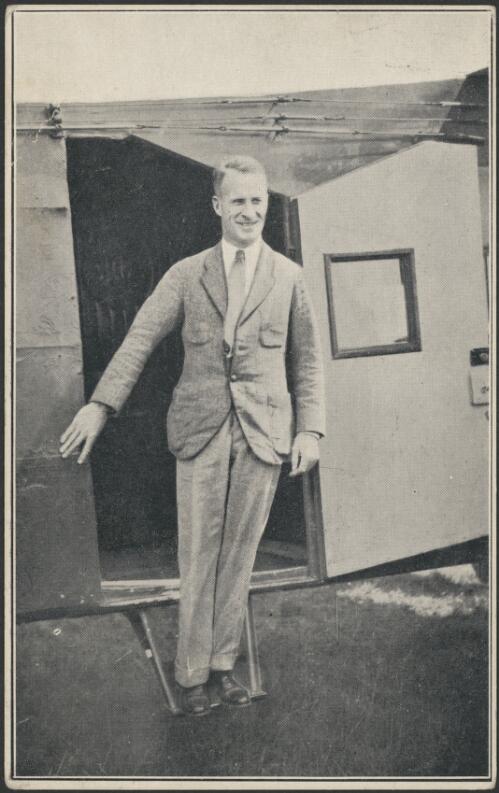 Portrait of Charles Kingsford Smith standing on steps of Fokker F. VII/3M monoplane, Southern Cross [picture]
