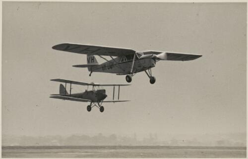 Broadbent and Maguire taking off in Puss Moth monoplane VH-UQK Australia-England flight, with biplane VH-UHQ behind, Mascot, New South Wales, 1935 [picture]