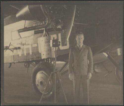 Sir Charles Kingsford Smith on arrival standing next to Southern Cross VH-USU, Mascot, New South Wales, 1935 [picture]