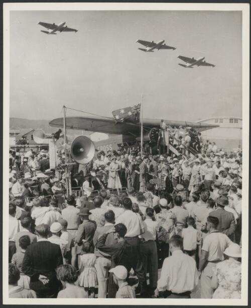 Southern Cross, VH-USU, at its placing in memorial at Eagle Farm, Brisbane, three Canberra bombers in the air, 1958 [picture]