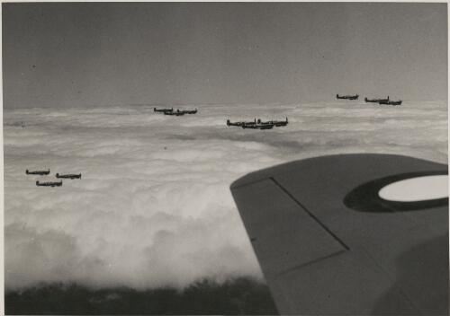 Spitfire kings flying high above the clouds alongside a Royal Australian Air Force bomber, ca. 1943 [picture]