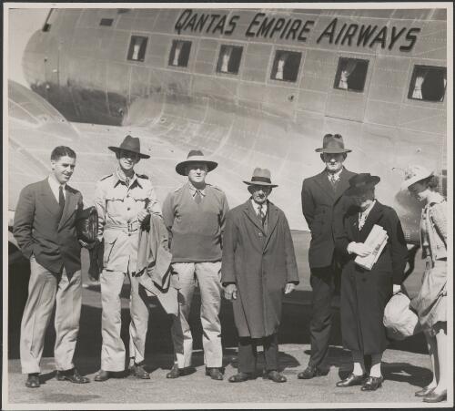 Passengers on first [Qantas Empire Airways] service to New Guinea at Mascot prior to departure, left to right, Mr D. Laurie (Cairns), Mr R.A. Batterby, Mr A.W. Coles (Port Moresby), Mr F. Jents, Mr H.S. Sullivan, Mrs A.M. Millar (Cairns), Miss P. Entricken (Townsville), 2 April, 1945 [picture] / Richard McKinney