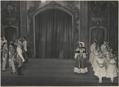 Igor Schwezoff as the Old General (front right of group on left), Borislav Runanine as the Head Mistress (left of group on right), Tatiana Riabouchinska as a junior girl (front row second from right), and artists of the company,  in Graduation ball, The Original Ballet Russe, Australian tour, His Majesty's Theatre, Melbourne, 1940 [picture] / Hugh P. Hall