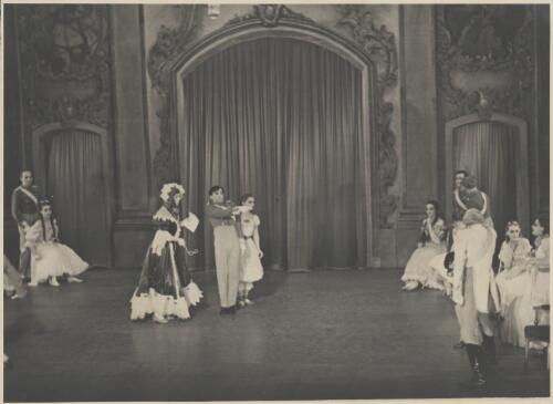 Borislav Runanine as the Head Mistress (centre left), David Lichine as a cadet (centre middle), Olga Morosova (?) as a junior girl (centre right), Igor Schwezoff as the Old General (front right back to audience), and artists of the company, in Graduation ball, The Original Ballet Russe, Australian tour, His Majesty's Theatre, Melbourne, 1940 [picture] / Hugh P. Hall