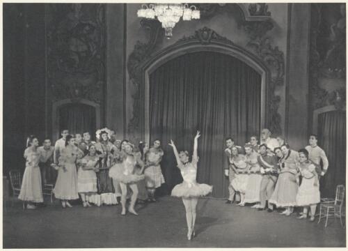 Borislav Runanine as the Head Mistress (centre of group on left), Genevieve Moulin as a Dance-step Competitor (centre of group on left wearing tutu), Alexandra Denisova as a Dance-step Competitor (centre front), David Lichine as a junior cadet (centre of group on right), Igor Schwezoff as the Old General (centre rear of group on right), and artists of the company, in Graduation ball, The Original Ballet Russe, Australian tour, His Majesty's Theatre, Melbourne, 1940 [picture] / Hugh P. Hall