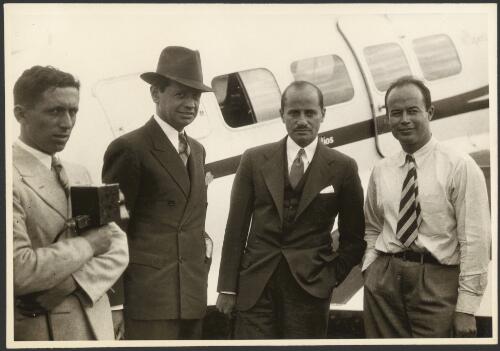 Group portrait showing an unidentified man, Joseph Rosthal, Arthur M. Loew, and Jimmy Dickson, during their round the world flight, Mascot, 1932 [picture] / Sydney Morning Herald and Sydney Mail