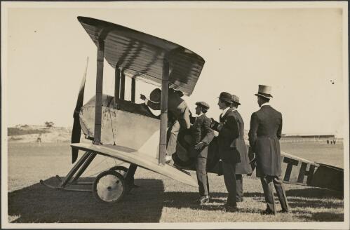 Harry Hawker takes the Governor-General, Lord Denman, for a flight in a Sopwith Tabloid as the State Governor, Sir Gerald Strickland, looks on, Randwick Racecourse, Saturday 21 February, 1914 [picture]