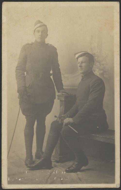 Charles Kingsford Smith, seated next to man standing, in Royal Flying Corps uniform [picture] / British Art Studios, London