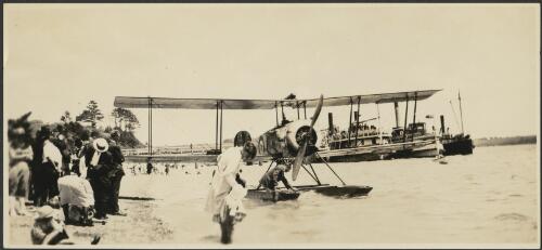 Seaplane, H2990, with ferries in background and crowd on shore, Auckland, New Zealand [picture]