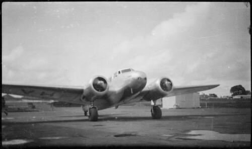 Guinea Airways Lockheed L-10 Electra twin engine monoplane, VH-UXH 'C.J. Levien' with engines running on airfield, ca. 1940, 2 [picture]